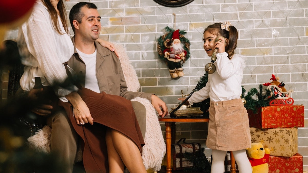 A group of people sitting around a christmas tree